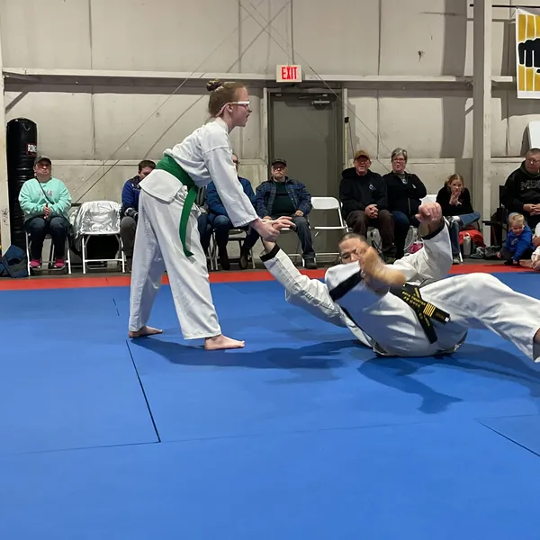 Teen student performing a takedown technique during sparring